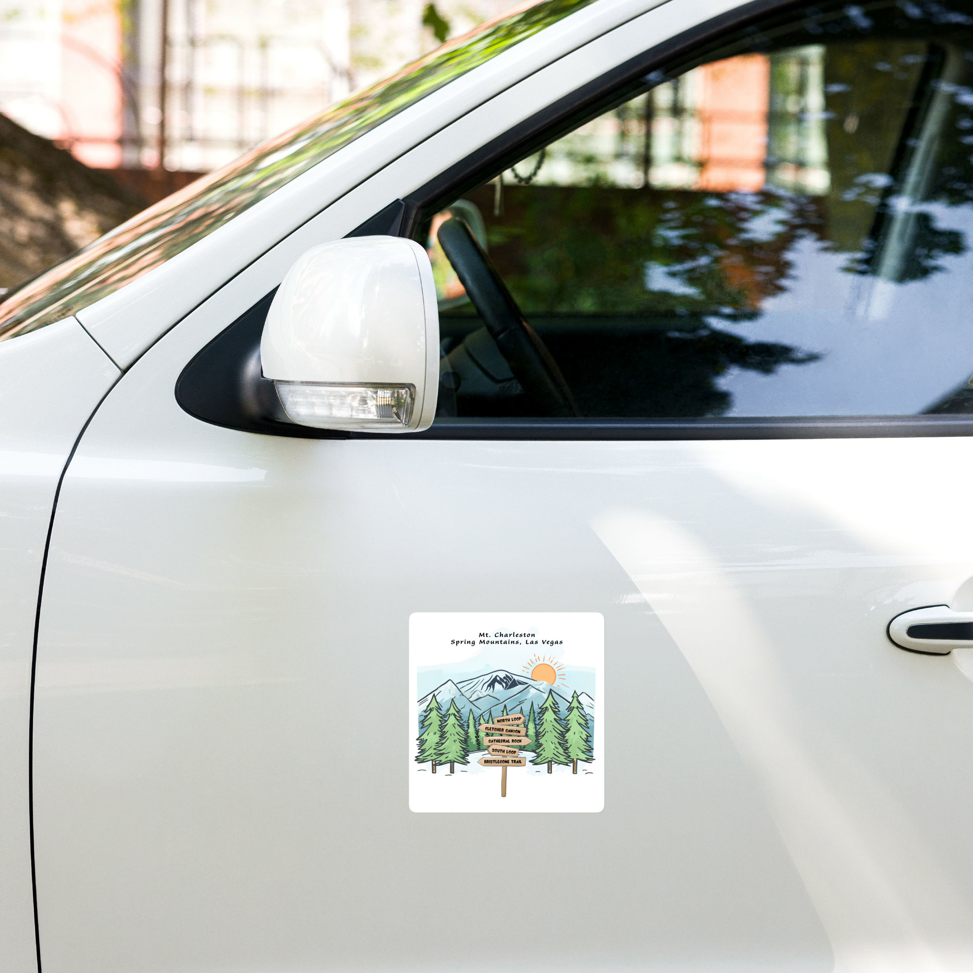 White car door with a colorful mountain poster attached, titled Mt. Charleston, Spring Mountains near Las Vegas